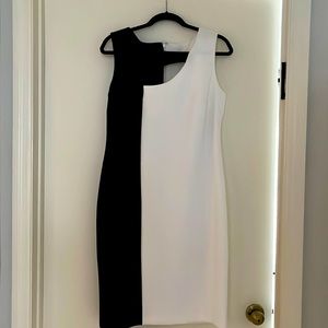 Medium black and white Calvin Klein dress with asymmetrical cut out in front.